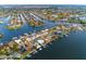 Aerial view of waterfront homes with docks and boat lifts in a canal neighborhood with direct ocean access at 6442 Lake Sunrise Dr, Apollo Beach, FL 33572