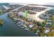Aerial view of waterfront homes with docks and boat lifts in a canal neighborhood with direct ocean access at 6442 Lake Sunrise Dr, Apollo Beach, FL 33572