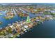 Aerial view of waterfront homes with docks and boat lifts in a canal neighborhood with direct ocean access at 6442 Lake Sunrise Dr, Apollo Beach, FL 33572