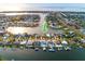 Aerial view of waterfront homes with docks and boat lifts in a canal neighborhood with direct ocean access at 6442 Lake Sunrise Dr, Apollo Beach, FL 33572