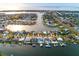 Aerial view of waterfront homes with docks and boat lifts in a canal neighborhood with direct ocean access at 6442 Lake Sunrise Dr, Apollo Beach, FL 33572