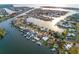Aerial view of waterfront homes with docks and boat lifts in a canal neighborhood with direct ocean access at 6442 Lake Sunrise Dr, Apollo Beach, FL 33572