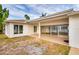 Rear exterior of waterfront property featuring a large tile patio at 6442 Lake Sunrise Dr, Apollo Beach, FL 33572