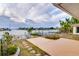 Landscaped backyard with waterfront views and access to the canal at 6442 Lake Sunrise Dr, Apollo Beach, FL 33572