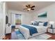 This bedroom includes a ceiling fan, hardwood floors, white walls, and a window with wooden blinds at 6442 Lake Sunrise Dr, Apollo Beach, FL 33572