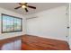 Bedroom featuring hardwood floors, a closet, a ceiling fan, and a window with wooden blinds at 6442 Lake Sunrise Dr, Apollo Beach, FL 33572