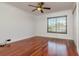 The bedroom has hardwood floors, white walls, a ceiling fan, and a window with wooden blinds at 6442 Lake Sunrise Dr, Apollo Beach, FL 33572