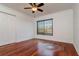 Bedroom featuring hardwood floors, white walls, a ceiling fan, and a window with wooden blinds at 6442 Lake Sunrise Dr, Apollo Beach, FL 33572
