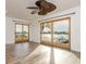 Spacious bedroom with wood-look floors, ceiling fan, and water views at 6442 Lake Sunrise Dr, Apollo Beach, FL 33572