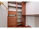 Walk-in closet with built-in wood shelving and drawers for storage at 6442 Lake Sunrise Dr, Apollo Beach, FL 33572