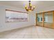 Bright dining room with tile floors, a chandelier, and a large window with views at 6442 Lake Sunrise Dr, Apollo Beach, FL 33572