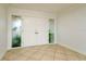 Elegant entryway featuring double doors with decorative glass and neutral tile flooring at 6442 Lake Sunrise Dr, Apollo Beach, FL 33572