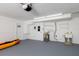 Garage featuring a storage sink, water heater, doors leading inside, and a kayak at 6442 Lake Sunrise Dr, Apollo Beach, FL 33572