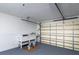 Garage featuring a workbench, paint supplies, a closed garage door, and a grey floor at 6442 Lake Sunrise Dr, Apollo Beach, FL 33572