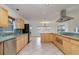 Spacious kitchen with stainless steel appliances, light wood cabinets, and tiled countertops at 6442 Lake Sunrise Dr, Apollo Beach, FL 33572