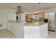Spacious kitchen with light wood cabinets, stainless steel appliances, and tiled countertops at 6442 Lake Sunrise Dr, Apollo Beach, FL 33572