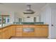 Close-up of kitchen showcasing light wood cabinets, stainless steel appliances, and a cooktop at 6442 Lake Sunrise Dr, Apollo Beach, FL 33572