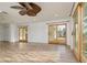 Bright living area with wood-look floors and sliding doors leading to outdoor spaces at 6442 Lake Sunrise Dr, Apollo Beach, FL 33572