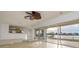 Open-concept space with stainless appliances, a water view, and large sliding doors at 6442 Lake Sunrise Dr, Apollo Beach, FL 33572