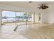 Bright living room with large sliding glass doors offering expansive waterfront views at 6442 Lake Sunrise Dr, Apollo Beach, FL 33572
