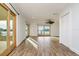 Bright living area featuring wood-look floors and sliding doors to water views at 6442 Lake Sunrise Dr, Apollo Beach, FL 33572