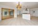 Open floorplan view with tiled floors, sliding glass doors, and partial kitchen view at 6442 Lake Sunrise Dr, Apollo Beach, FL 33572