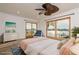 Bedroom with water view, ceiling fan, dresser, and sliding glass doors at 6442 Lake Sunrise Dr, Apollo Beach, FL 33572