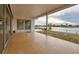 Covered tile patio boasting open waterfront views at 6442 Lake Sunrise Dr, Apollo Beach, FL 33572