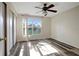 Bedroom featuring hard surface floors, a fan, a window, and a closet at 6842 Dartmouth Hill St, Riverview, FL 33578