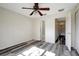 Bedroom with hard surface floors, fan, and a view into the bathroom and hallway at 6842 Dartmouth Hill St, Riverview, FL 33578