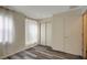 Cozy bedroom featuring wood floors, a window with coverings and a closet with bi-fold doors at 6842 Dartmouth Hill St, Riverview, FL 33578