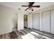 Bedroom with hard surface floors, fan, closet, and door leading to the bathroom at 6842 Dartmouth Hill St, Riverview, FL 33578