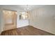 Open dining area with wood floors, leading to the kitchen and entryway, perfect for modern living at 6842 Dartmouth Hill St, Riverview, FL 33578