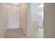 Inviting entryway with neutral tile flooring, leading to a bright kitchen with white appliances and ample storage space at 6842 Dartmouth Hill St, Riverview, FL 33578