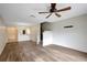 Spacious living room boasts new flooring, ceiling fan, and staircase leading to the second floor at 6842 Dartmouth Hill St, Riverview, FL 33578