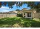 A private backyard features a covered patio and sliding glass door for easy indoor-outdoor living at 7031 Kendall Heath Way, Land O Lakes, FL 34637
