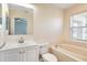 The bathroom features a tub and shower combination, a white toilet, and a vanity sink at 7031 Kendall Heath Way, Land O Lakes, FL 34637