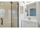 Bathroom with glass shower and vanity with ample lighting at 7031 Kendall Heath Way, Land O Lakes, FL 34637