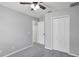 Bedroom features neutral walls, a ceiling fan, carpet, and a closet with shelving for storage at 7031 Kendall Heath Way, Land O Lakes, FL 34637