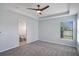 Spacious bedroom with a ceiling fan, a walk-in closet, and an ensuite bathroom at 7031 Kendall Heath Way, Land O Lakes, FL 34637