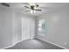 Cozy bedroom with a ceiling fan, closet, and a window providing natural light at 7031 Kendall Heath Way, Land O Lakes, FL 34637