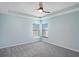 Spacious bedroom with neutral carpet, two windows, and ceiling fan at 7031 Kendall Heath Way, Land O Lakes, FL 34637