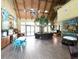 Large community room with wood floors, beamed ceiling, art, seating, and play area at 7031 Kendall Heath Way, Land O Lakes, FL 34637
