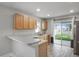 Modern kitchen with stainless steel appliances, breakfast bar and sliding doors at 7031 Kendall Heath Way, Land O Lakes, FL 34637