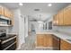 Functional kitchen with modern appliances, open layout, and connecting dining and living areas at 7031 Kendall Heath Way, Land O Lakes, FL 34637
