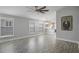 Spacious living area with wood-look floors open to the kitchen and abundant natural light at 7031 Kendall Heath Way, Land O Lakes, FL 34637