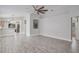 Open concept living room with wood-look floors and abundant natural light at 7031 Kendall Heath Way, Land O Lakes, FL 34637