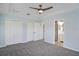 Bright main bedroom with closet, ensuite bath, and ceiling fan at 7031 Kendall Heath Way, Land O Lakes, FL 34637