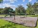 Community playground nestled on a grassy lawn with mature trees and fun for everyone at 7031 Kendall Heath Way, Land O Lakes, FL 34637