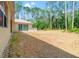 Spacious backyard with lush greenery, offering a serene outdoor retreat and potential for landscaping opportunities at 7340 West Dr, Wesley Chapel, FL 33544